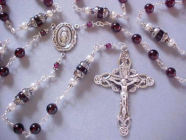 Handmade sterling silver wire wrapped rosary with genuine garnet gemstone and freshwater button pearls. Handmade sterling silver wire wrapped rosary with genuine garnet gemstone and freshwater button pearls.