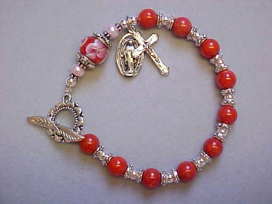 Rosary Bracelet with Red Coral, floral lampwork glass, Silver Plated sunflower clasp with crucifix and miraculous medal dangles Rosary Bracelet with Red Coral, floral lampwork glass, Silver Plated sunflower clasp with crucifix and miraculous medal dangles