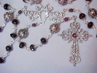 rare museum quality rosary with garnet rondelles capped in Bali Silver, ornate filigree Bali Silver Our Fathers, Elaborate Renaissance design sterling silver cross with garnet stone and cherubs center, all sterling wire wrapped construction rare museum quality rosary with garnet rondelles capped in Bali Silver, ornate filigree Bali Silver Our Fathers, Elaborate Renaissance design sterling silver cross with garnet stone and cherubs center, all sterling wire wrapped construction