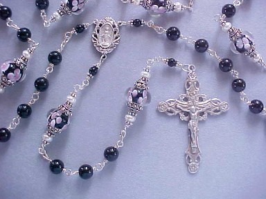 Black Tourmaline handmade rosary with lampworked floral glass. All sterling silver wire wrapped construction Black Tourmaline handmade rosary with lampworked floral glass. All sterling silver wire wrapped construction